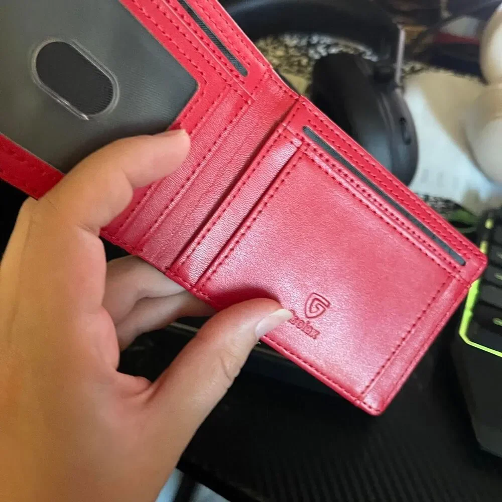 Men’s carbon fiber style wallet with bright red interior.